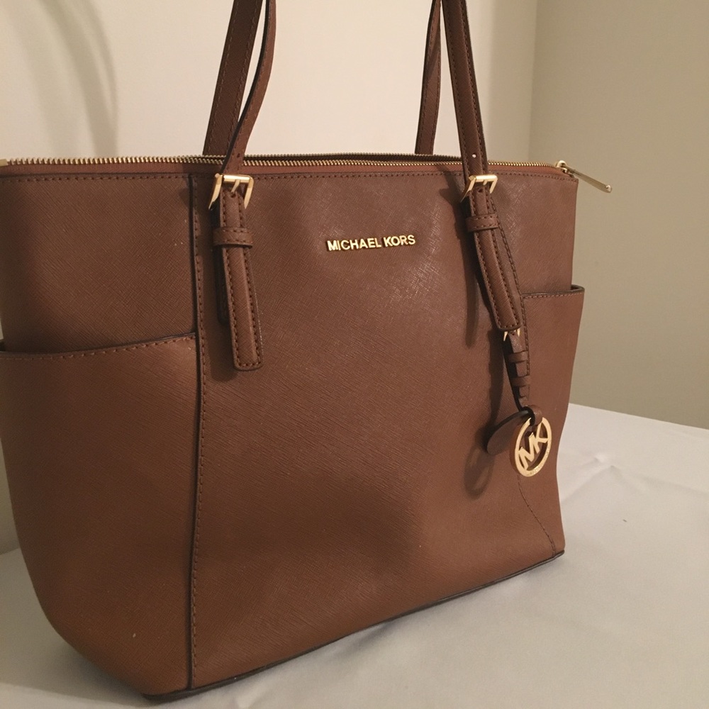 Woman’s Michael Kors brown leather purse